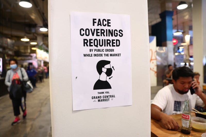 A sign is posted about required face coverings in Grand Central Market on July 19, 2021, in Los Angeles.