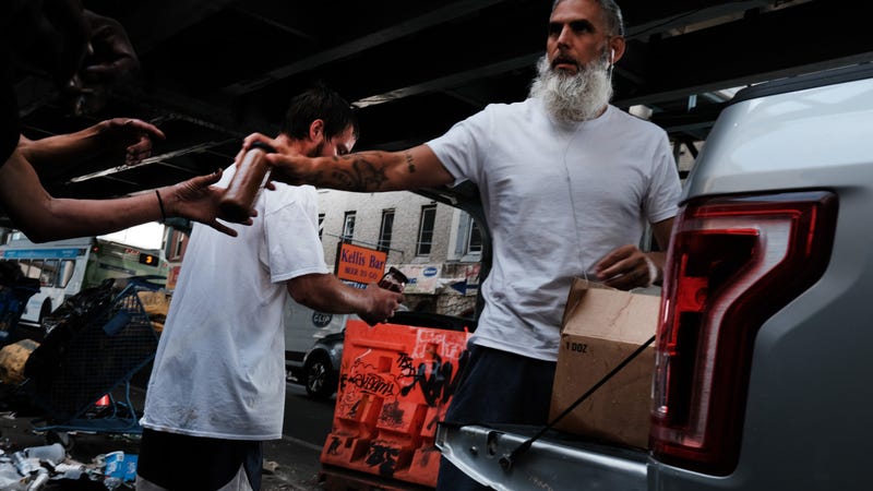 People gather in a street overtaken by heroin users in Kensington on July 19, 2021 in Philadelphia, Pennsylvania.