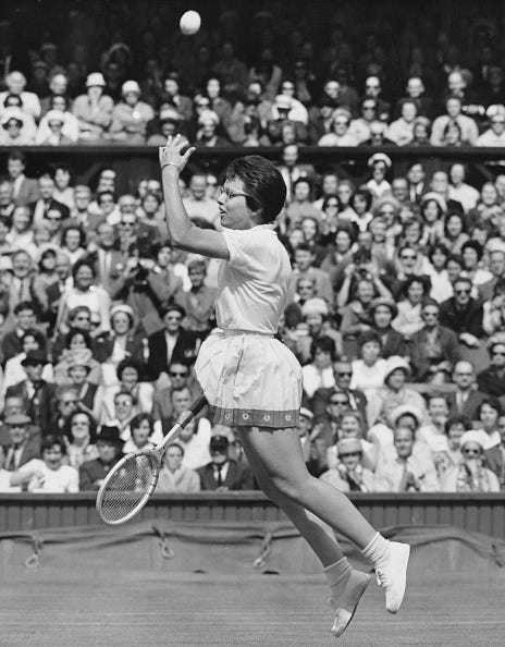 Billie Jean Moffitt of the United States throws the tennis ball away as she jumps into the air in celebration after defeating Margaret Court of Australia in their Women's Singles Second Round match on Centre Court at the Wimbledon Lawn Tennis Championship on 27th June 1962