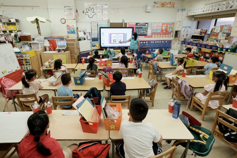 A teacher at Yung Wing School P.S. 124 goes over a lesson on a monitor with in-person Summer program students on July 22, 2021 in New York City.