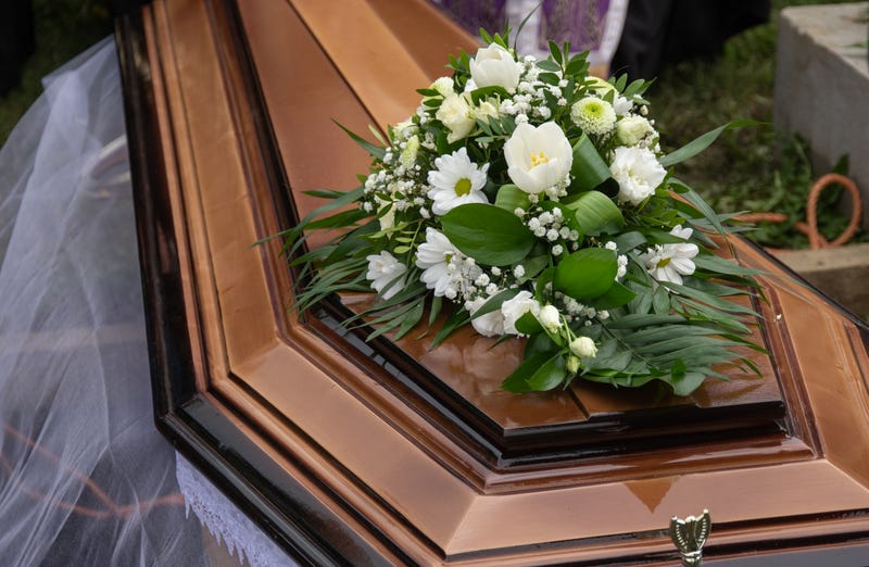 Bouquet of white flowers on a coffin.