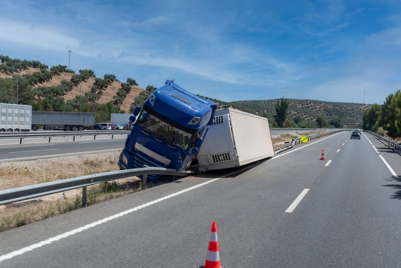semi overturned in the median of the highway