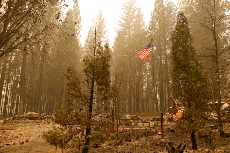 An American flag flies over a home that was destroyed by the Dixie Fire on July 26, 2021 in Indian Falls, California.