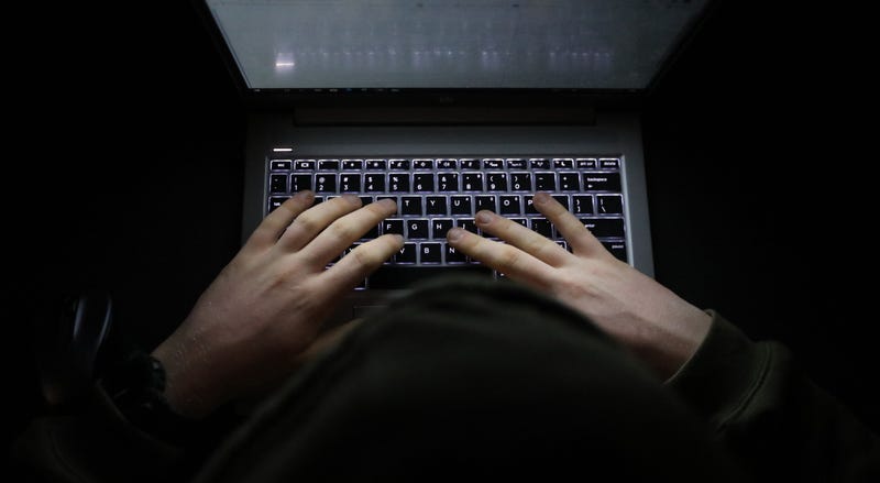Person using laptop in the dark