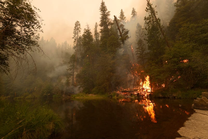 The Dixie Fire burns along the Feather River on July 26, 2021 near Quincy, California