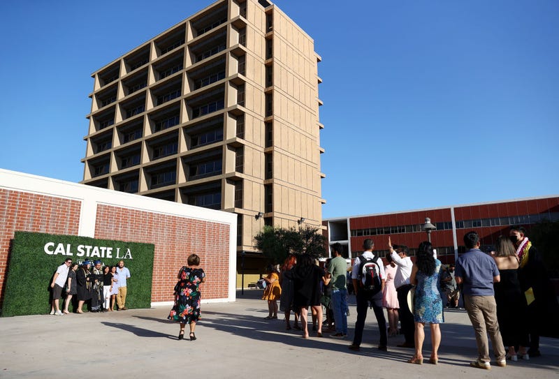 Cal State Los Angeles graduates and loved ones line up to take photos following their commencement ceremony which was held outdoors beneath a tent on campus on July 27, 2021 in Los Angeles, California.