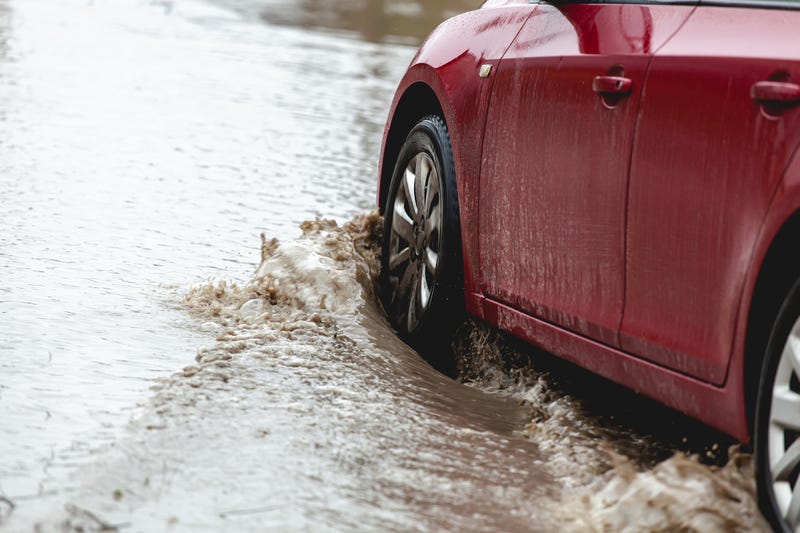 Car stuck in the mud, car wheel in a dirty puddle, rough terrain