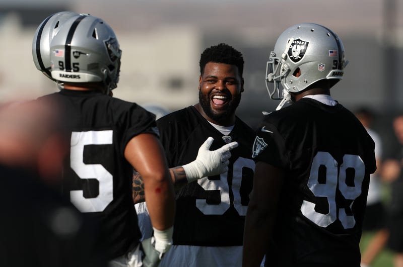 ohnathan Hankins #90 of the Las Vegas Raiders talks with teammates during training camp at the Las Vegas Raiders Headquarters/Intermountain Healthcare Performance Center on July 29, 2021