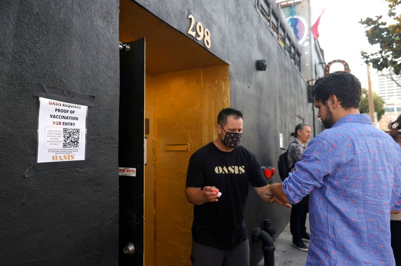 A doorman at Oasis checks a customer's vaccination card before allowing him to enter on July 29, 2021 in San Francisco, California.