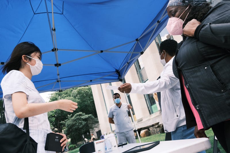 People sign-up for a shot at a city-operated mobile pharmacy for the COVID-19 vaccine in a Brooklyn neighborhood on July 30, 2021 in New York City