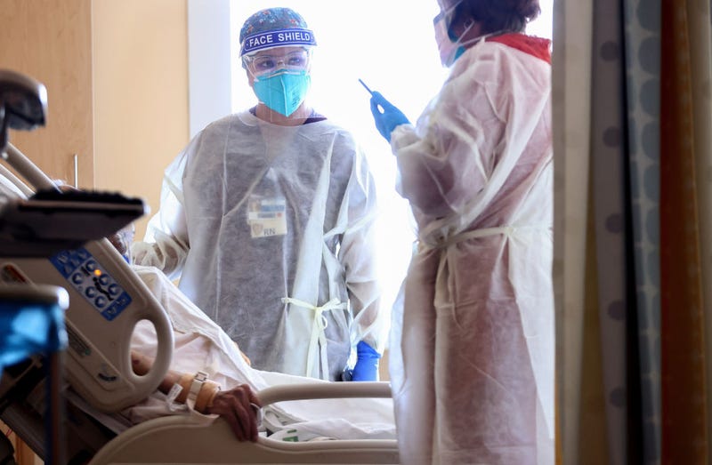 Registered nurse (RN) Elle Lauron (C) cares for a COVID-19 patient in the improvised COVID-19 unit at Providence Holy Cross Medical Center in the Mission Hills neighborhood on July 30, 2021, in Los Angeles, California.