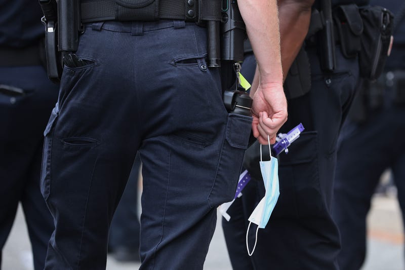 Police officers carrying face masks.