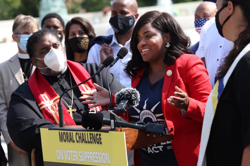 Texas State Representatives Jasmine Crockett (D-District 100) speaks alongside Rev. William Barber, Co-Chair of the Poor People’s Campaign, and fellow representatives, as they prepare to deliver a petition to Senate Majority Leader Charles Schumer calling for an end to the filibuster, the passage of the For The People Act and restoring the Voting Rights Act, at the U.S. Supreme Court on August 12, 2021, in Washington, DC.