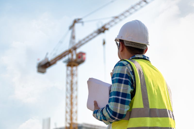 civil engineer looking up at a crane