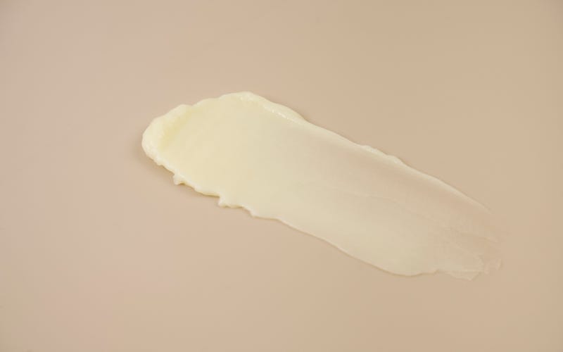 cleansing balm smeared on beige background