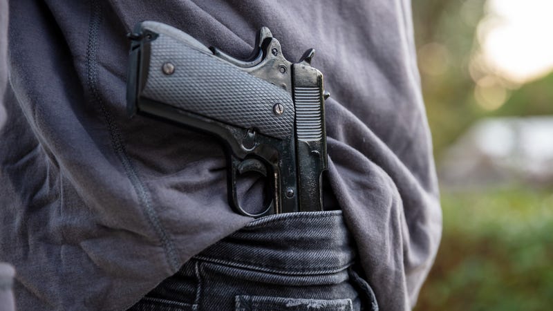 A person carrying a gun.