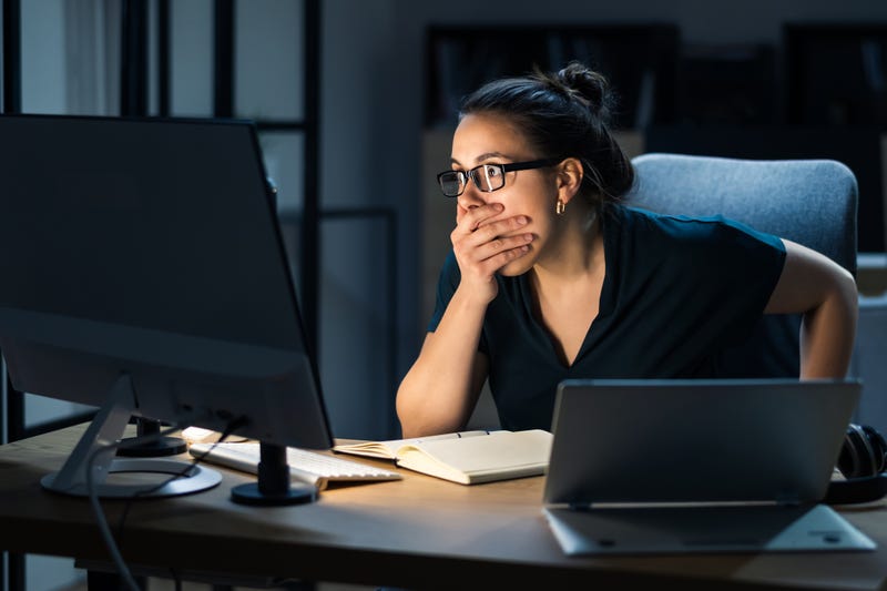 Woman shocked at computer screen stock photo. 
