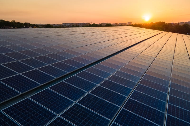 solar panels with sun shining on them