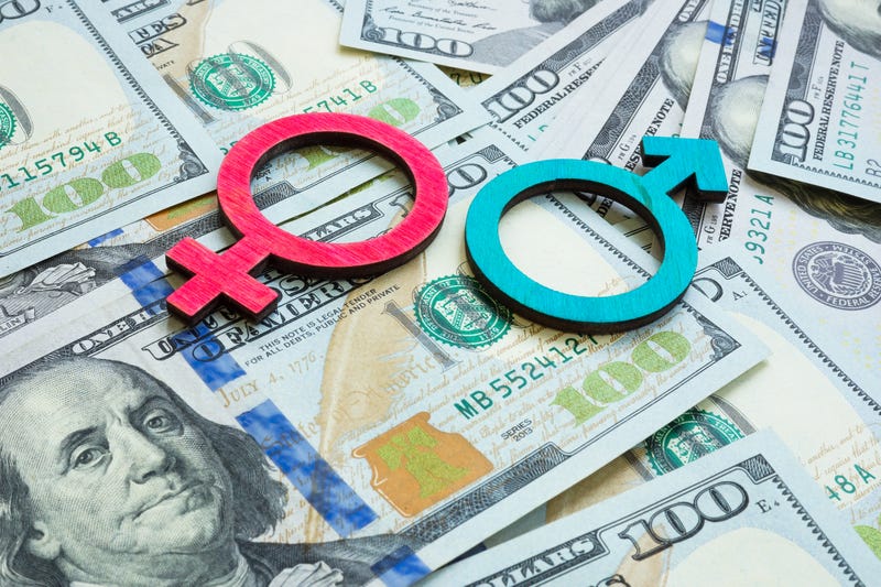 male and female sign over dollar bills