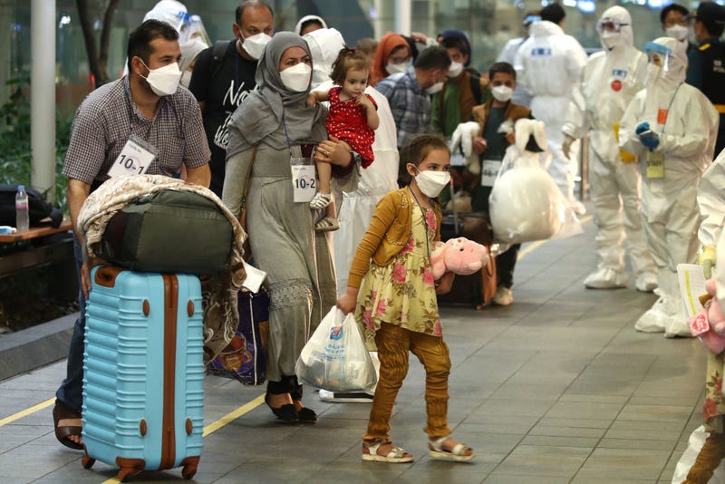 Evacuees from Afghanistan arrive at Incheon International Airport on August 26, 2021 in Incheon, South Korea. A total of 378 Afghans arrived in South Korea on Thursday as part of Seoul's efforts to evacuate local co-workers of the country's embassy and other facilities in the war-torn nation after the Taliban's seizure of power. 