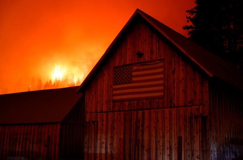 The Caldor Fire burns in the hills above homes on August 30, 2021 near South Lake Tahoe, California.