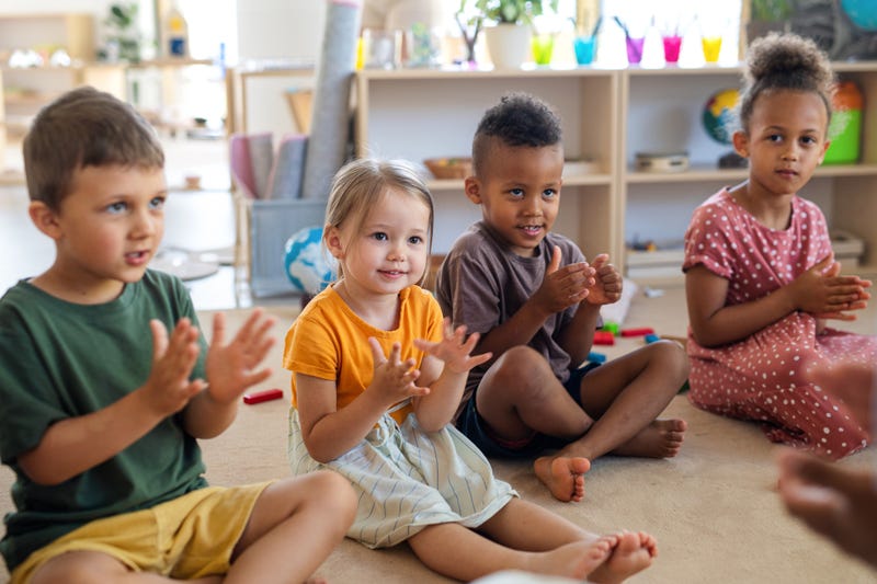 kids in a pre-school classroom clapping their hands