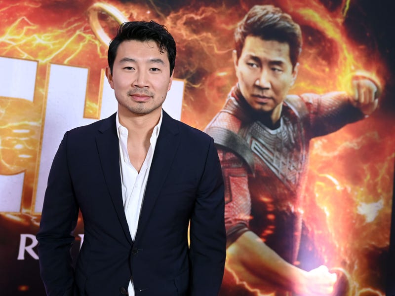 Simu Liu in front of a "Shang-Chi" display at the film's Toronto premiere.