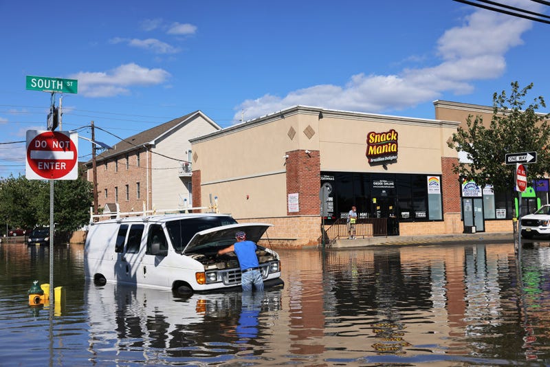 Abilio Viegas attempts to fix his flooded van on South Street on September 02, 2021 in Newark, New Jersey. 
