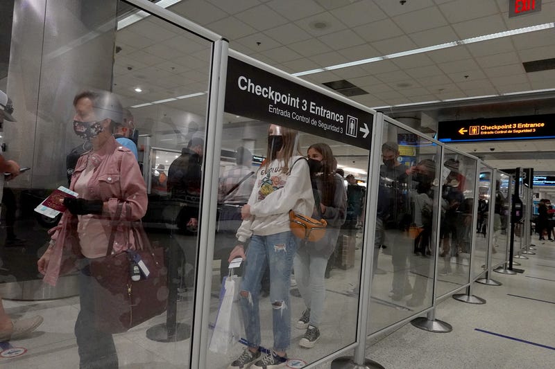 Travelers wait in line at the TSA checkpoint in the Miami International Airport before starting the Labor Day weekend on September 03, 2021 in Miami, Florida. 
