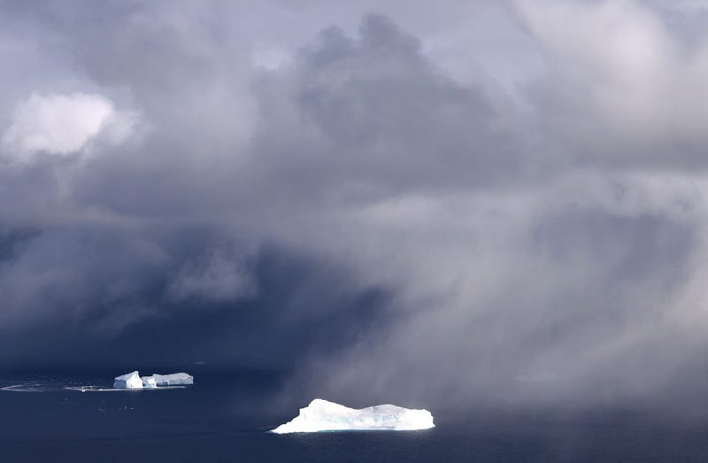 Icebergs and light snowfall are seen from NASA's Oceans Melting Greenland (OMG) research aircraft near the west coast on September 7, 2021 above Greenland. The NASA Oceans Melting Greenland (OMG) campaign is wrapping up a six-year mission studying the ocean and glaciers along Greenland’s 24,000 mile remote coastline with airborne and shipborne instruments- data which cannot be captured by satellite. Each summer, OMG releases around 250 ocean probes from a modified DC-3 aircraft into the ocean to monitor the temperature and salinity of Atlantic subsurface waters around Greenland. According to NASA, the goal of the mission is ‘to figure out how much of Greenland’s ice melt is caused by warming oceans.’ Greenland’s massive ice sheet holds enough water to raise sea levels by around 25 feet worldwide. (Photo by Mario Tama/Getty Images)