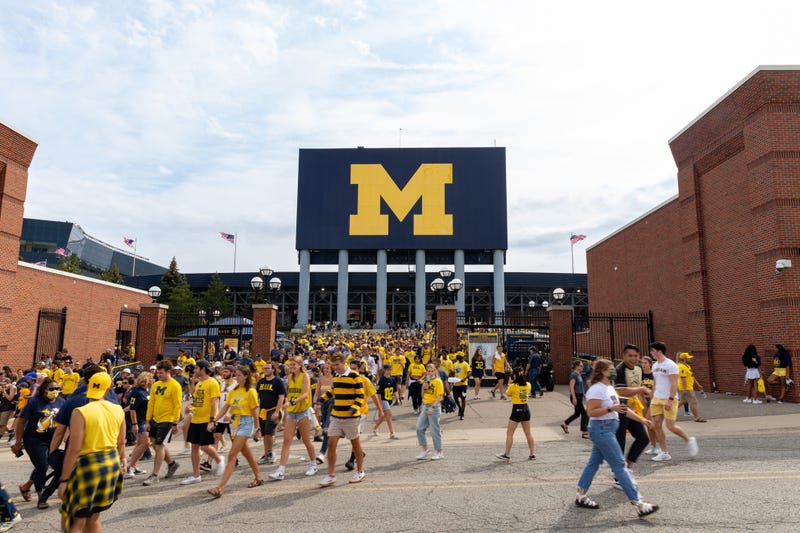 Unidentified Fans exit Michigan Stadium after a University of Michigan football game
