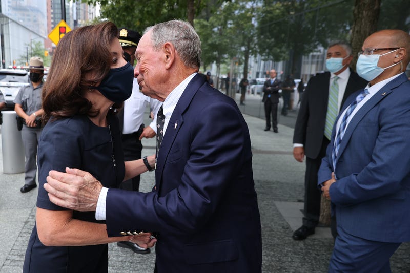 Gov. Kathy Hochul (L) is greeted by former Mayor Mike Bloomberg before they toured the 9/11 Memorial & Museum and laid flowers at the edge of the south memorial pool on September 08, 2021