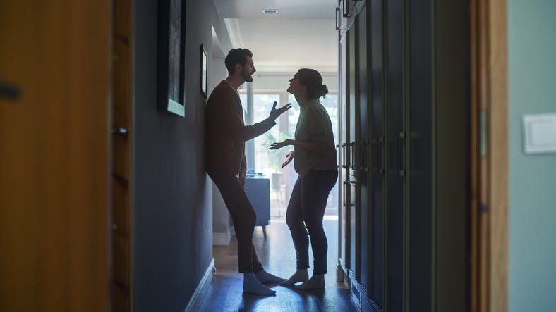 Couple arguing in a hallway
