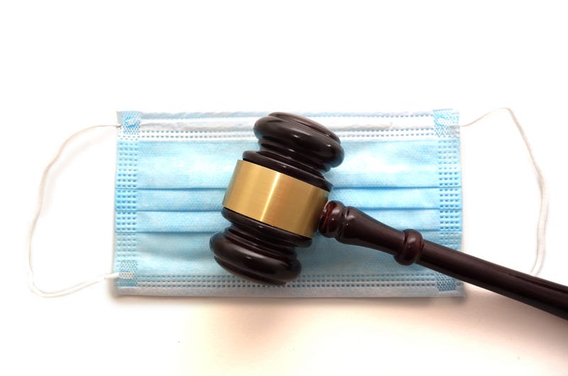 Court legal gavel and facemask isolated on white -- Coronavirus mask mandate concept