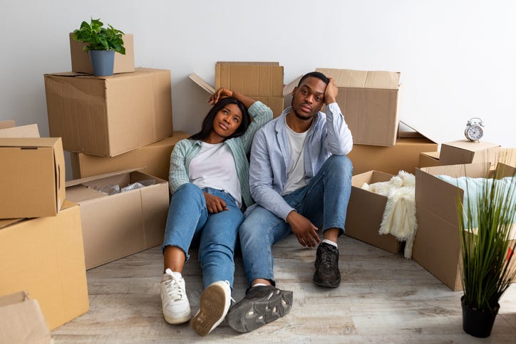 Couple exhausted from moving. 
