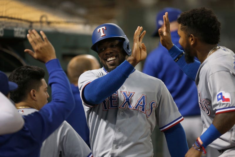 Adolis Garcia #53 of the Texas Rangers celebrates after scoring on a double by Nathaniel Lowe #30 in the top of the third inning against the Oakland Athletics at RingCentral Coliseum on September 10, 2021 in Oakland, California.