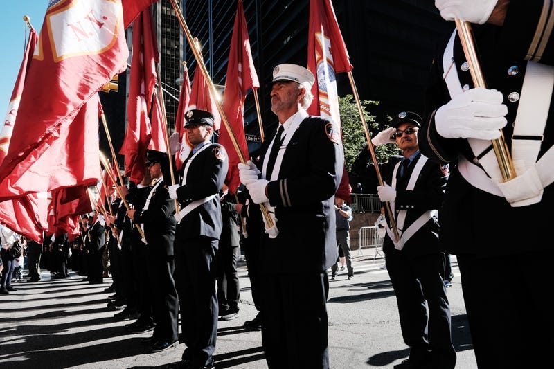 Firefighters gather in lower Manhattan near Ground Zero as the city commemorates the 20th anniversary of the September 11th terrorist attacks on the World Trade Center on September 11, 2021 in New York City.