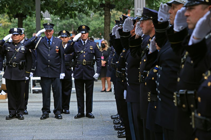 Members of the 9/11 Honor Guard salute at the end of their duty at the National 9/11 Memorial at the conclusion of a commemoration ceremony on Sept. 11, 2021.