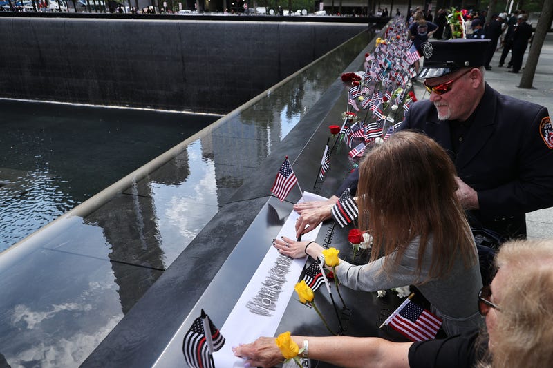 People make rubbings of the names of the victims of the 9/11 attacks and in the 1993 World Trade Center bombing that are inscribed along the memorial pools at the National 9/11 Memorial on September 11, 2021 in New York City. The nation is marking the 20th anniversary of the terror attacks of September 11, 2001, when the terrorist group al-Qaeda flew hijacked airplanes into the World Trade Center, Shanksville, PA and the Pentagon, killing nearly 3,000 people.