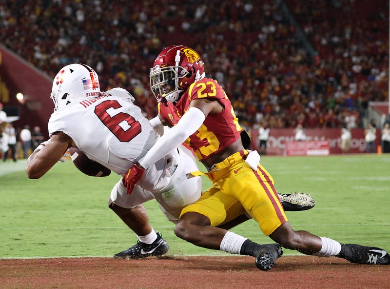 football player tackles another football player in the endzone