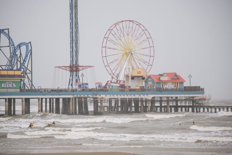 People surf ahead of the Tropical Storm Nicholas on Sept. 13, 2021, in Galveston, Texas.