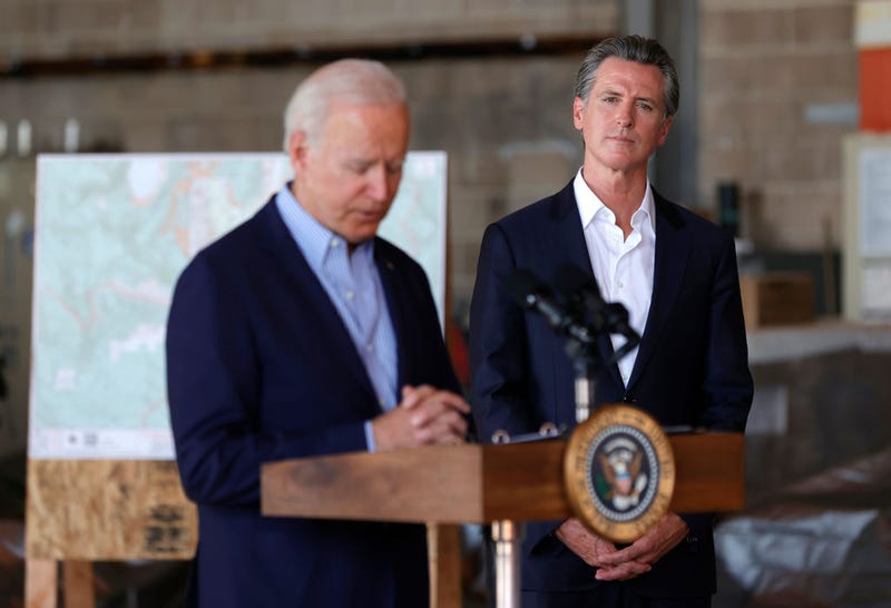 California Gov. Gavin Newsom (R) looks on as U.S. President Joe Biden delivers remarks to reporters after doing a helicopter tour of the Caldor Fire, at Mather Airport on September 13, 2021 in Mather, California.