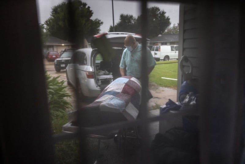 A funeral home worker transports the body of a woman, 54, who died of Covid-19 in her bed at home on September 13, 2021 in Houston, Texas. She had not been vaccinated, citing fears of the vaccination shot, according to her daughter. Texas' Harris County continues to see large number of Covid-19 hospitalizations due to the Delta variant surge in the state. (Photo by John Moore/Getty Images)