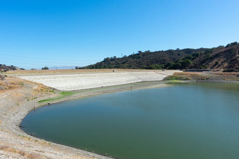 FILE - Stevens Creek reservoir at 12% capacity in September 2021. Tall concrete dam of almost dried, low water level Stevens Creek reservoir in San Francisco Bay Area, California