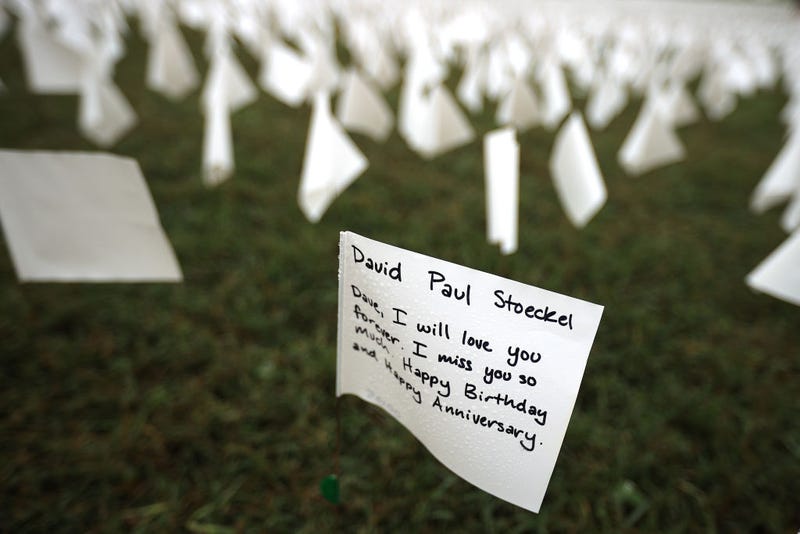 A personal message to a person who died of COVID-19 is written on a small flag that is part of 'In America: Remember,' a public art installation commemorating all the Americans who have died of the coronavirus near the Washington Monument on September 17, 2021 in Washington, DC.