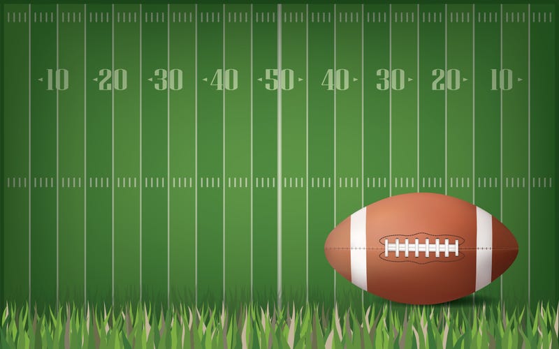 Football on green field pattern background