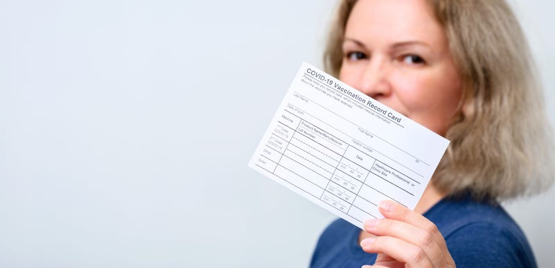 Vaccinated young woman showing COVID-19 Vaccination Record Card, happy person after getting corona virus vaccine, panoramic banner background. Concept of coronavirus vaccine shot, proof and people.