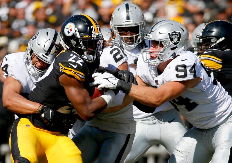 Running back Najee Harris #22 of the Pittsburgh Steelers runs with the ball against defensive end Carl Nassib #94 of the Las Vegas Raiders in the fourth quarter of the game at Heinz Field on September 19, 2021.