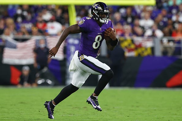 Lamar Jackson models the Ravens purple uniform tops. 