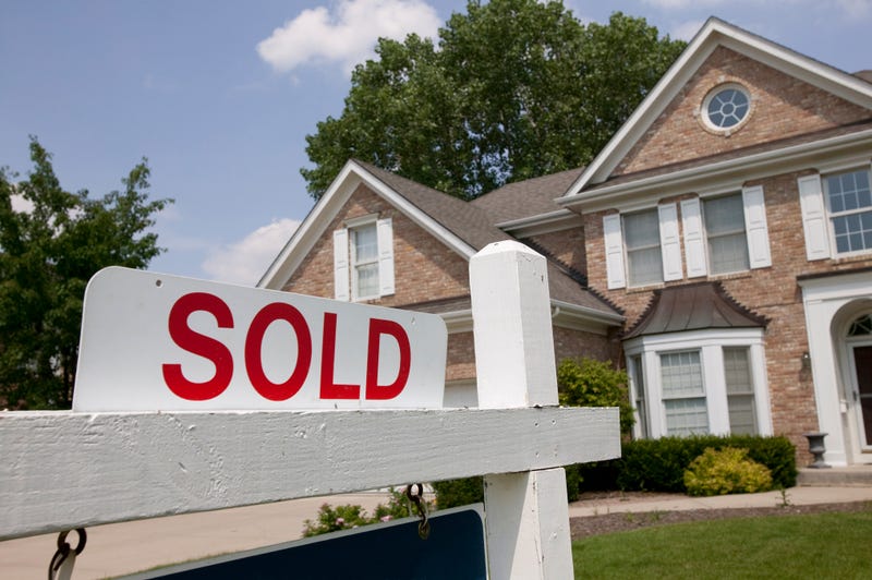 A house with a sold sign in front.